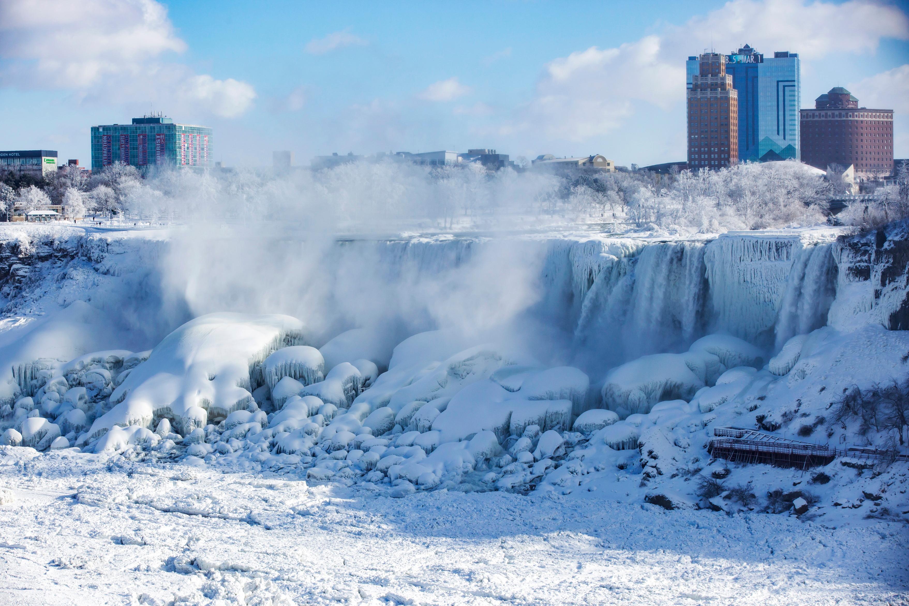 ice and water flows over the american falls, seen from niagara